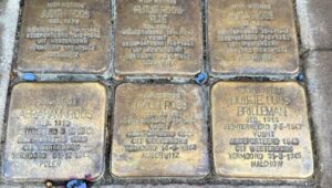 The small gold blocks in the streets of Amsterdam are called Stolpersteine, or "stumbling stones". These brass plaques are Holocaust memorials created by German artist Gunter Demnig. 